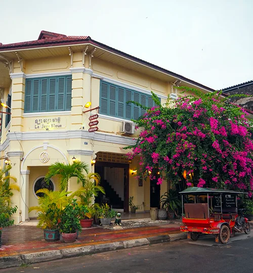 Colonial-style building with tuk-tuk